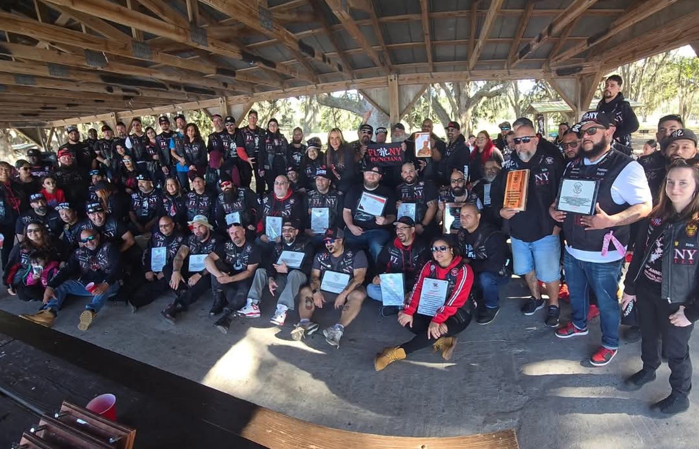 FLNY Ryderz chapter group photo with banner